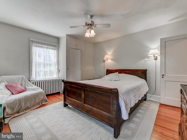 326 Saint Dunstans Rd, Baltimore, MD 21212 - bedroom featuring radiator, wood finished floors, a ceiling fan, a closet, and baseboards