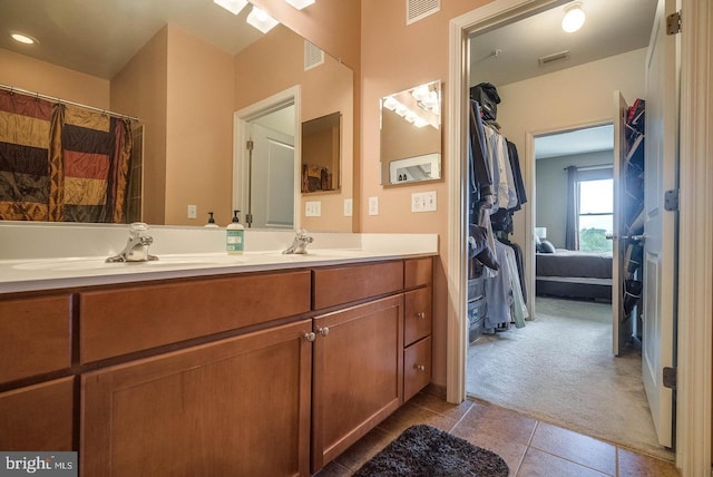 1391 Pennsylvania Ave SE Unit 471, Washington, DC 20003 - bathroom featuring double vanity, tile patterned floors, and connected bathroom