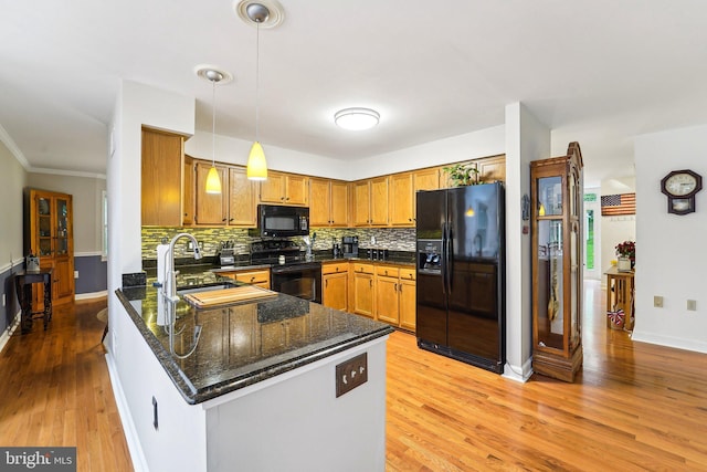 4270 Deborah Ct, Mount Airy, MD 21771 - kitchen with black appliances, a peninsula, light wood finished floors, backsplash, and a sink