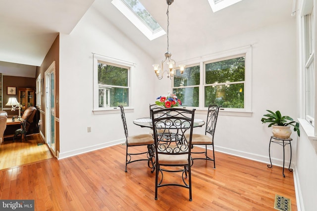 4270 Deborah Ct, Mount Airy, MD 21771 - dining area featuring a skylight, light wood finished floors, lofted ceiling, a chandelier, and baseboards