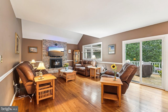 4270 Deborah Ct, Mount Airy, MD 21771 - living area featuring hardwood / wood-style floors, lofted ceiling, a brick fireplace, and baseboards