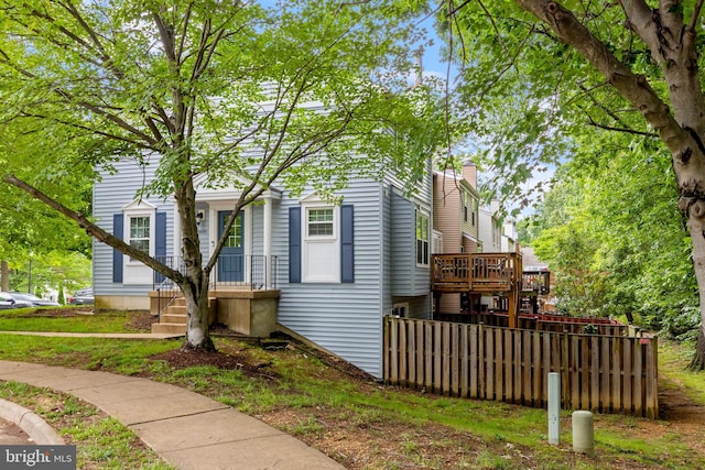 6600 Rockleigh Way, Alexandria, VA 22315 - view of front facade with a wooden deck and a chimney