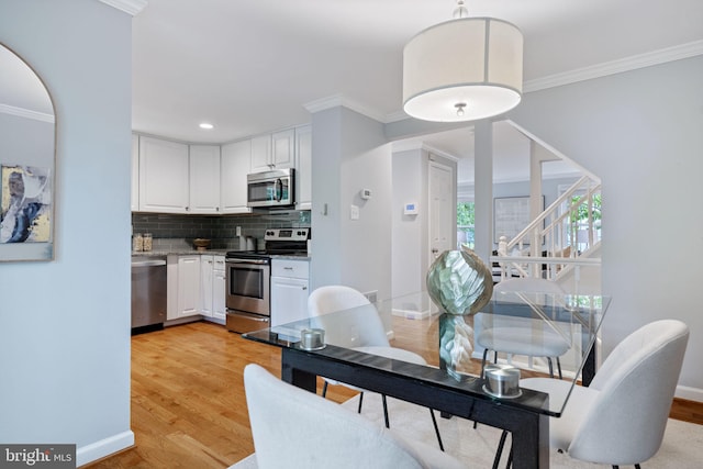 6600 Rockleigh Way, Alexandria, VA 22315 - dining space with baseboards, crown molding, light wood-style flooring, stairway, and recessed lighting