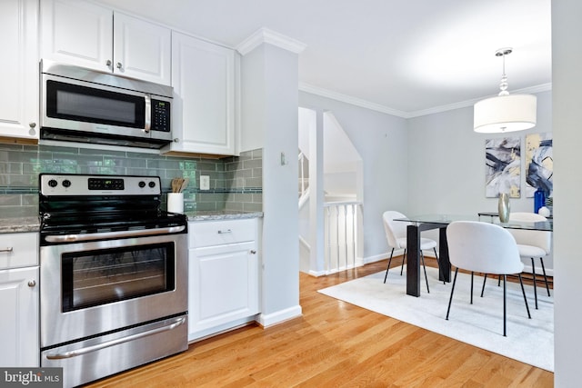 6600 Rockleigh Way, Alexandria, VA 22315 - kitchen featuring stainless steel appliances, crown molding, decorative backsplash, white cabinetry, and light wood-style flooring