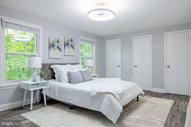 6600 Rockleigh Way, Alexandria, VA 22315 - bedroom with multiple closets, baseboards, and wood finished floors