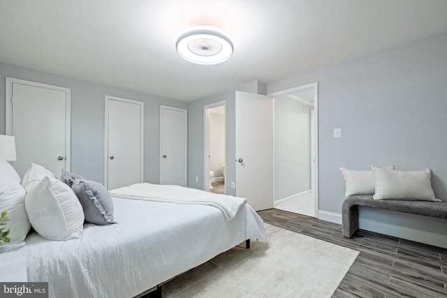 6600 Rockleigh Way, Alexandria, VA 22315 - bedroom with wood finished floors, baseboards, and connected bathroom