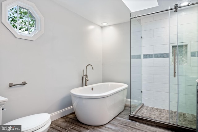 6600 Rockleigh Way, Alexandria, VA 22315 - bathroom featuring a freestanding bath, toilet, a stall shower, wood finished floors, and baseboards