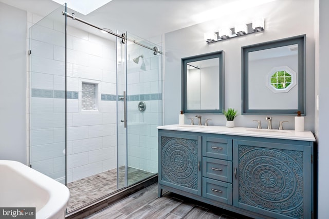 6600 Rockleigh Way, Alexandria, VA 22315 - bathroom featuring a shower stall, a freestanding tub, double vanity, and wood finished floors