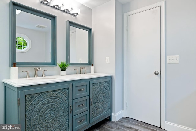 6600 Rockleigh Way, Alexandria, VA 22315 - bathroom featuring wood finish floors, double vanity, and baseboards