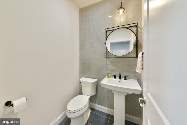 45 Lavender Dr, Yardley, PA 19067 - bathroom with tile walls, toilet, tile patterned flooring, and a sink