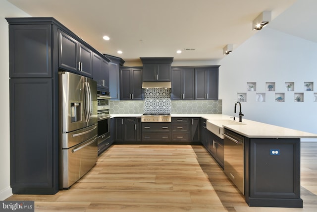 45 Lavender Dr, Yardley, PA 19067 - kitchen with appliances with stainless steel finishes, a sink, a peninsula, light countertops, and backsplash