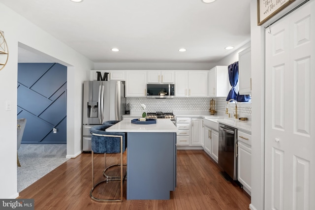 140 N Allwood Dr, Hanover, PA 17331 - kitchen featuring stainless steel appliances, white cabinetry, dark wood-style floors, a breakfast bar area, and a center island
