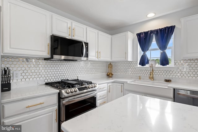 140 N Allwood Dr, Hanover, PA 17331 - kitchen featuring appliances with stainless steel finishes, a sink, white cabinetry, tasteful backsplash, and recessed lighting