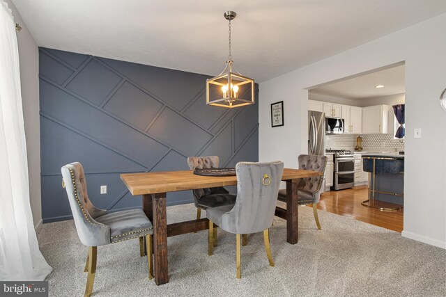 140 N Allwood Dr, Hanover, PA 17331 - dining room with a decorative wall, light carpet, a chandelier, and baseboards