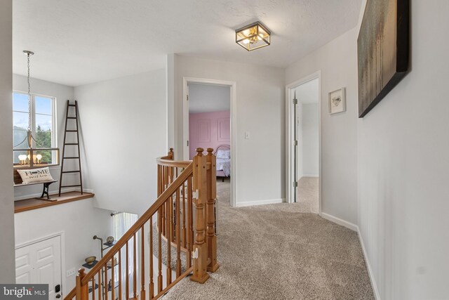 140 N Allwood Dr, Hanover, PA 17331 - hall with an upstairs landing, carpet flooring, a chandelier, and baseboards