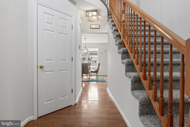 140 N Allwood Dr, Hanover, PA 17331 - stairway featuring wood finished floors, baseboards, and a chandelier