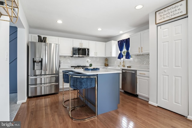 140 N Allwood Dr, Hanover, PA 17331 - kitchen with appliances with stainless steel finishes, a kitchen island, white cabinetry, a sink, and recessed lighting