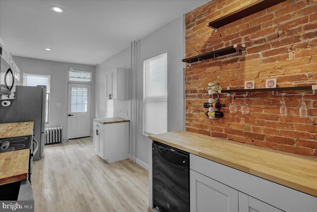 918 Spring St, Reading, PA 19604 - kitchen with butcher block countertops, radiator, dishwasher, light wood-style flooring, and recessed lighting