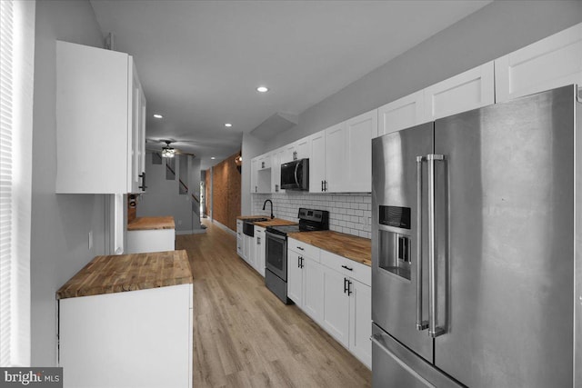918 Spring St, Reading, PA 19604 - kitchen featuring stainless steel appliances, butcher block countertops, recessed lighting, white cabinets, and light wood finished floors