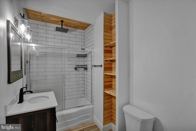 918 Spring St, Reading, PA 19604 - full bathroom featuring vanity, toilet, a combined bath / shower with rainfall shower, and wood finished floors