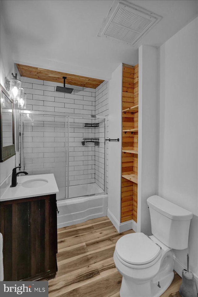 918 Spring St, Reading, PA 19604 - bathroom featuring toilet, vanity, wood finished floors, and a combined bath / shower with rainfall shower