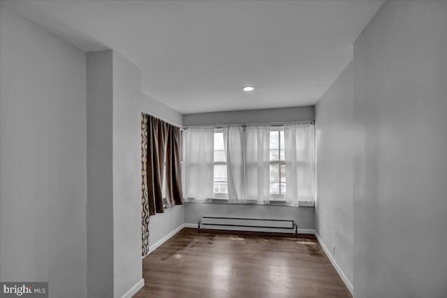 918 Spring St, Reading, PA 19604 - empty room with baseboard heating, wood finished floors, baseboards, and recessed lighting