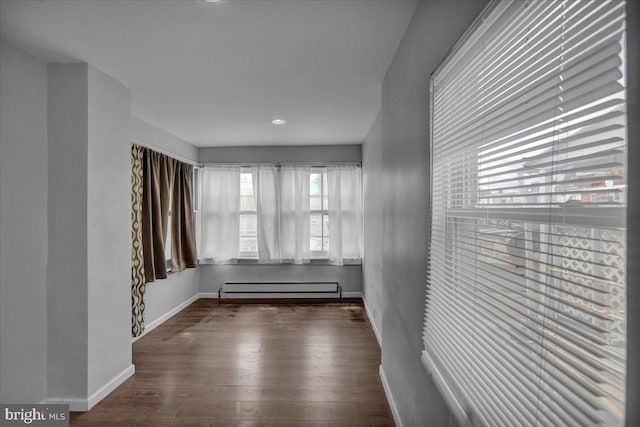 918 Spring St, Reading, PA 19604 - spare room with a baseboard heating unit, wood finished floors, baseboards, and recessed lighting