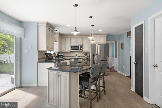 202 Prancer Rd, Egg Harbor Township, NJ 08234 - kitchen featuring stainless steel appliances, cream cabinets, decorative backsplash, light wood-type flooring, and baseboards