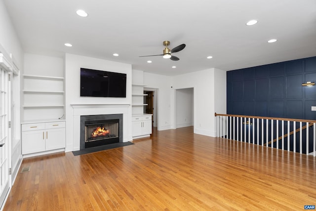 329 Carrsbrook Dr, Charlottesville, VA 22901 - unfurnished living room with ceiling fan, a fireplace with flush hearth, light wood-style flooring, built in shelves, and recessed lighting