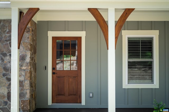 329 Carrsbrook Dr, Charlottesville, VA 22901 - doorway to property with board and batten siding, a porch, and stone siding