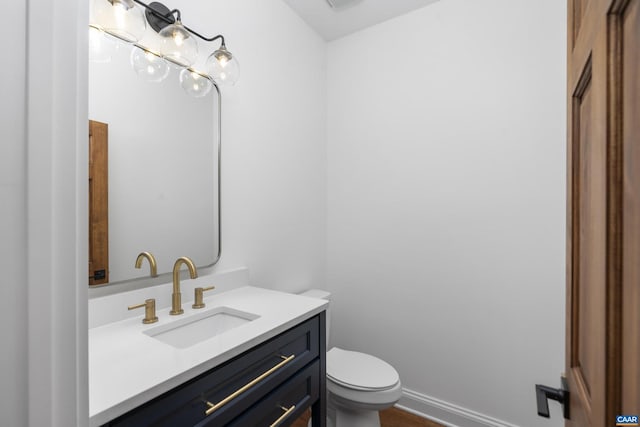 329 Carrsbrook Dr, Charlottesville, VA 22901 - half bathroom featuring vanity, toilet, baseboards, and wood finished floors