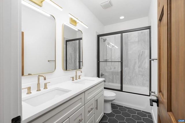 329 Carrsbrook Dr, Charlottesville, VA 22901 - full bathroom featuring toilet, double vanity, enclosed tub / shower combo, tile patterned flooring, and recessed lighting