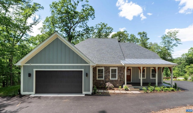 329 Carrsbrook Dr, Charlottesville, VA 22901 - view of front facade featuring a garage, driveway, roof with shingles, covered porch, and stone siding