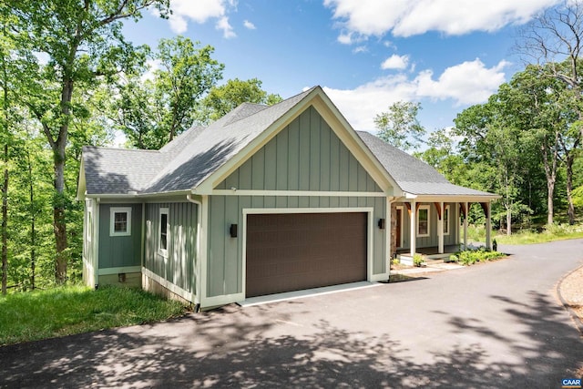 329 Carrsbrook Dr, Charlottesville, VA 22901 - view of front of property featuring an attached garage, driveway, roof with shingles, board and batten siding, and covered porch