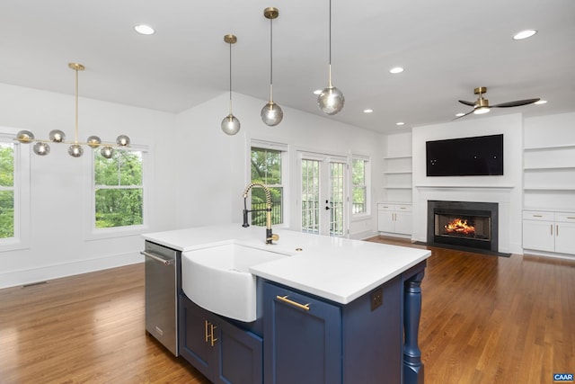 329 Carrsbrook Dr, Charlottesville, VA 22901 - kitchen with a sink, blue cabinets, dishwasher, light countertops, and recessed lighting