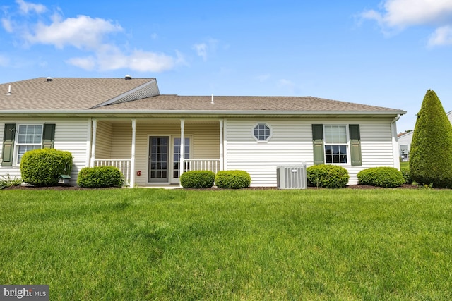 1389 Chami Dr Unit 171, Spring Grove, PA 17362 - rear view of property featuring central air condition unit, a lawn, a shingled roof, and a porch