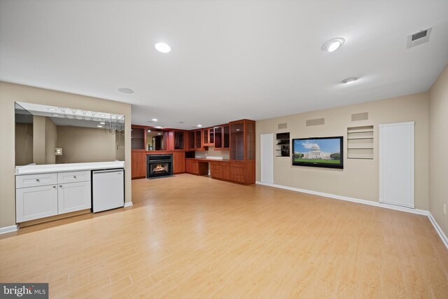 2300 Yvonnes Way, Dunn Loring, VA 22027 - unfurnished living room featuring a warm lit fireplace, light wood-style floors, baseboards, and recessed lighting