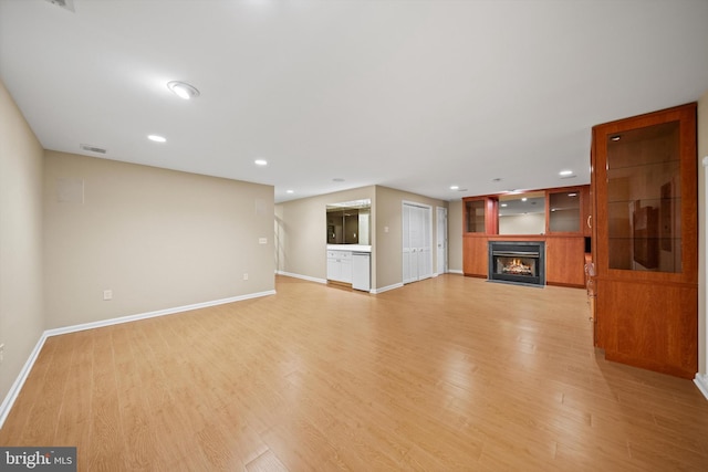 2300 Yvonnes Way, Dunn Loring, VA 22027 - unfurnished living room featuring a warm lit fireplace, light wood-style flooring, baseboards, and recessed lighting
