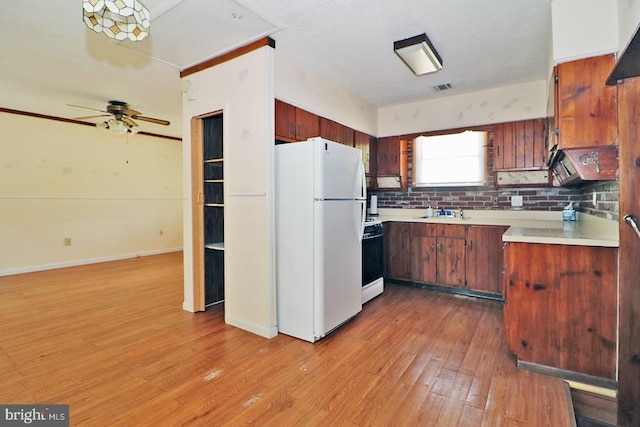 827 Rogers St, Lanoka Harbor, NJ 08734 - kitchen with freestanding refrigerator, light countertops, light wood-style flooring, stove, and tasteful backsplash