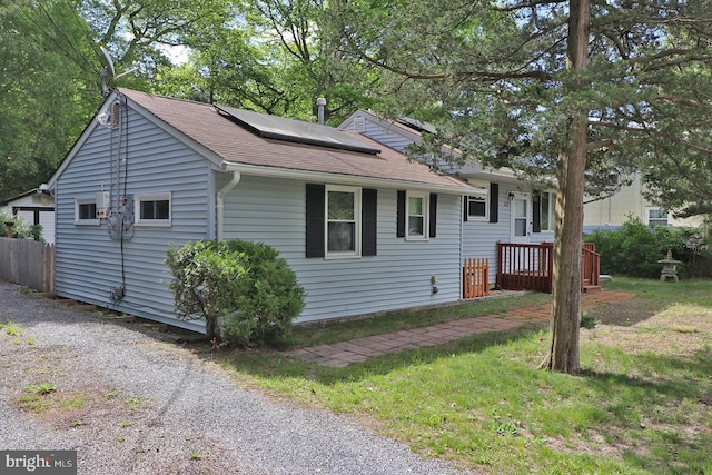 827 Rogers St, Lanoka Harbor, NJ 08734 - view of front facade with roof mounted solar panels and roof with shingles