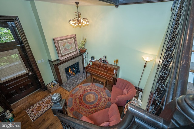 206 Price Ave Unit 2, Narberth, PA 19072 - living area featuring wood finished floors, a fireplace with flush hearth, and a chandelier