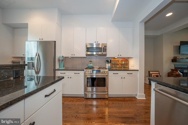 206 Price Ave Unit 2, Narberth, PA 19072 - kitchen with stainless steel appliances, dark wood finished floors, backsplash, white cabinets, and recessed lighting
