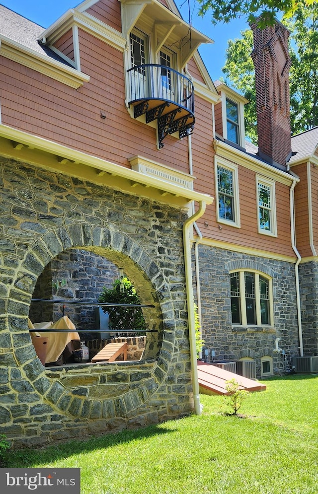 206 Price Ave Unit 2, Narberth, PA 19072 - rear view of property with stone siding, a balcony, a chimney, and a yard