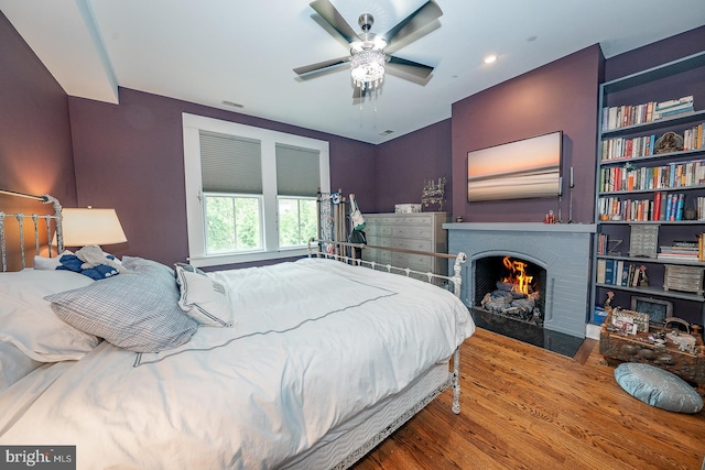 206 Price Ave Unit 2, Narberth, PA 19072 - bedroom with wood finished floors, a fireplace, and a ceiling fan