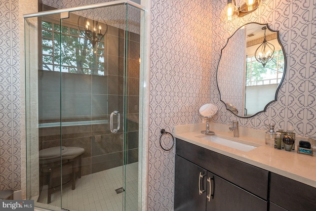 206 Price Ave Unit 2, Narberth, PA 19072 - bathroom featuring a chandelier, vanity, a shower stall, wallpapered walls, and toilet