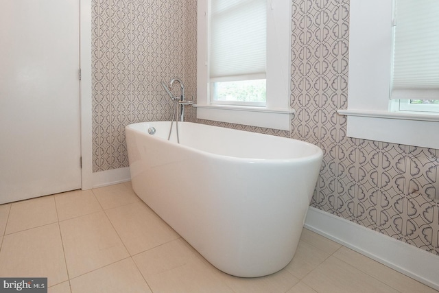 206 Price Ave Unit 2, Narberth, PA 19072 - bathroom with wallpapered walls, a freestanding tub, tile patterned floors, and baseboards