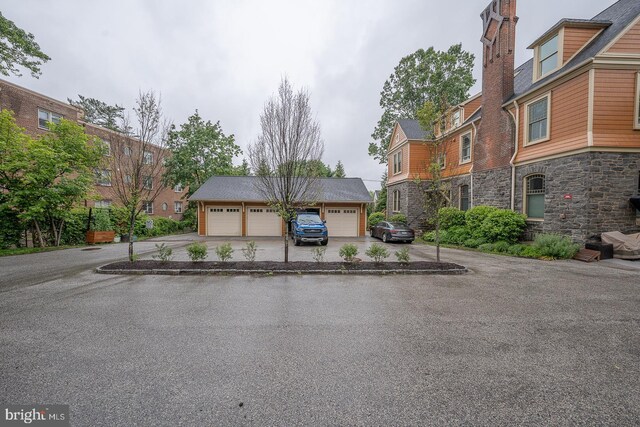 206 Price Ave Unit 2, Narberth, PA 19072 - view of front of house with a detached garage, stone siding, and a residential view