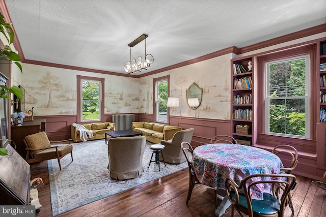 101 Warren Ave, Sewell, NJ 08080 - dining space featuring a wainscoted wall, radiator, hardwood / wood-style flooring, crown molding, and a chandelier