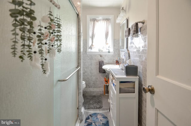 518 S Glenwood St, Allentown, PA 18104 - bathroom featuring vanity, tile walls, toilet, and a stall shower