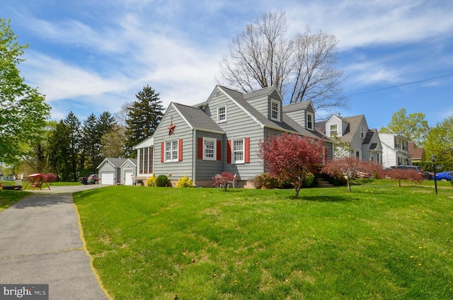 518 S Glenwood St, Allentown, PA 18104 - view of front facade featuring a front yard, a detached garage, an outdoor structure, and a shingled roof